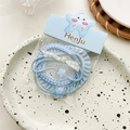 Detail of blue candy-colored elastic hair ties and fabric scrunchies on display - Blue