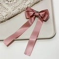Detail of pink satin three-layer bow hair clip with long ribbons on a beige tray - Deep Pink