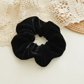 Elegant black velvet scrunchie for hair styling on a vintage lace and straw background - Black