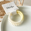 Macro view of spiral hair ties in gradient cream and yellow on a card - Gradient Goose Yellow