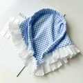 Detailed close-up of blue gingham cotton headscarf with white ruffled lace edges - Blue Plaid