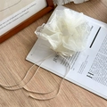 Elegant white lace bow scrunchie made of sheer organza on a rustic wooden background - White