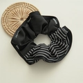 Detail of nautical style scrunchie with CHANGE lettering and striped pattern design - Navy Black Striped Scrunchie