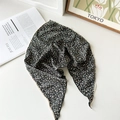 Detailed close-up of floral chiffon kerchief with vintage lace trim on white surface - Black Floral