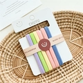 Detail of multi-colored pastel elastic hair bands set in a woven basket arrangement - Wide Light Multicolor