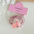 Détail de breloques raquette de badminton et volant sur élastiques à cheveux roses - Rose