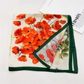 Detail view of floral silk scarf with vibrant poppy prints and green contrast borders - Abundant Flowers