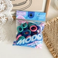 Colorful baby size high-elastic hair ties in a transparent pouch on a wood surface - Style A