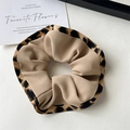Detailed view of leopard print scrunchie with khaki fabric and ruffled texture - Leopard Ruffle Khaki