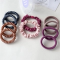 Detail of multi-style hair ties set including spiral cords and fabric scrunchies - Purple