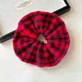 Close-up of red and black checkered knit oversized scrunchie with soft wool texture - Red and Black Knitted Scrunchie