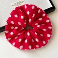 Detail of red knitted oversized scrunchie with white polka dots and heart shape accent - Red Geometric Knitted Scrunchie