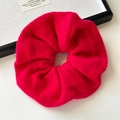Detail of oversized fuchsia knit scrunchie showing soft texture and elastic pleats - Red