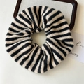 Close-up of a black and white striped knitted scrunchie with soft yarn texture details - Black Stripe