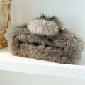 Detailed macro view of large dark grey faux fur hair claw clip on a textured white surface - 15cm Square Brown