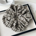 Detail of a large vintage brown plaid scrunchie with a woven texture and small brand tag - Preppy Khaki Plaid