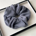 Detailed view of a dark grey plush scrunchie showing thick fleece fabric and soft texture - Large Plush Blue