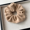 Close-up of soft plush coffee-colored hair scrunchie with textured fleece in a tray - Small Plush Khaki