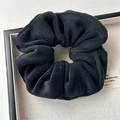 Close-up of black plush velvet scrunchie showing soft texture and high elastic material - Small Plush Black