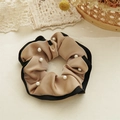 Detail view of premium champagne satin scrunchie with faux pearls and black edge trim - Beaded Style / Brown