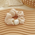 Close-up of champagne silk scrunchie with a square faux pearl and golden trim - Large Pearl Style / Khaki