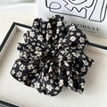Detail of elegant black floral scrunchie with cream flowers on a decorative tray - Yellow Floral
