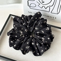 Detail of elegant black floral scrunchie on silk-lined tray with artistic card - Small Floral Black