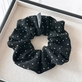Detailed close-up of a black shimmering scrunchie with a Blind for Love textile label - Black Rhinestone Scrunchie (FQ4242)