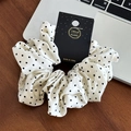 Detail of white polka dot hair scrunchie with silky fabric on branded card - Large Polka Dot White