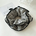 Detail of floral scrunchie with delicate black botanical pattern and piped edges - White Floral