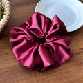 Detail of a silky burgundy satin scrunchie on a rustic wooden table background - 16cm Wine Red