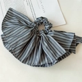 Detail of elegant black and white striped scrunchie with oversized ruffle design - Black Skirted Scrunchie