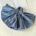 Detailed view of large blue and white striped fabric scrunchie with wide pleated edges - Blue Skirted Scrunchie
