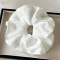 Detail shot of large white pleated scrunchie showing delicate fabric texture and ruffles - White Pleated Style