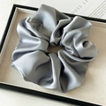Detailed view of grey satin oversized scrunchie on beige tray with elegant texture - Large / Blue Gray