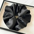 Close-up of black satin oversized scrunchie showing smooth silk texture and pleats - Large / Black