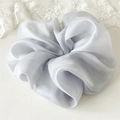 Detail of premium light gray satin scrunchie with silky luster on lace background - Gray