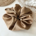 Close-up of premium champagne gold satin scrunchie with silk texture on lace fabric - Large / Camel