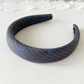 Detailed macro view of the padded fabric headband with blue bow print and diagonal stripes - Gray