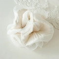 Detail of elegant ivory organza scrunchie with layered pleated edges and soft texture - Off White