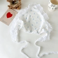 Detail of baby bonnet with blue bow pattern, delicate lace edges and polka dot mesh ties - Blue Bow