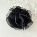 Detail of elegant black pleated organza hair scrunchie with a floral-like ruff design - Black
