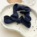 Detail of navy blue pleated satin fabric texture on a bow-knot elastic scrunchie - Navy Blue Knotted