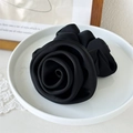Close-up of black satin rose hair scrunchie on a ceramic plate with elegant fabric texture - Rose Shape / Black
