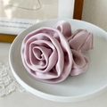 Detail of elegant satin rose scrunchie in dusty pink with soft silk-like texture - Rose Shape / Dusty Pink