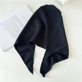 Detail shot of solid black triangle headscarf texture with elegant flat lay setting - Black