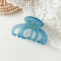 Detailed macro view of a light blue acetate octopus claw clip with France Handmade gold stamp - Lake Blue