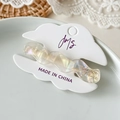 Elegant wavy acetic acid hair clip in pearlescent white finish on display card - Wave Transparent White