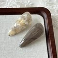 Detail view of two acetate water-drop hair clips with marble texture on lace background - Grey-Beige