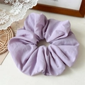 Detailed view of the textured light purple scrunchie on a decorative rustic background - Purple